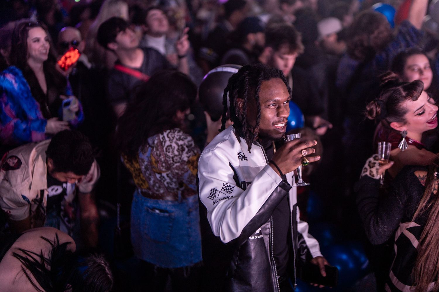 Concert audience enjoying live music performance in dimly lit venue.