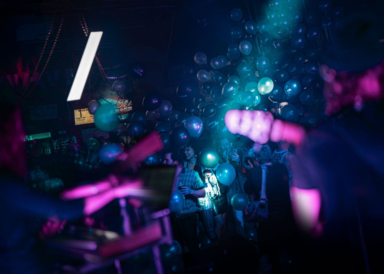Abstract nightclub scene with bubbles and colorful lighting creating dreamy atmosphere.