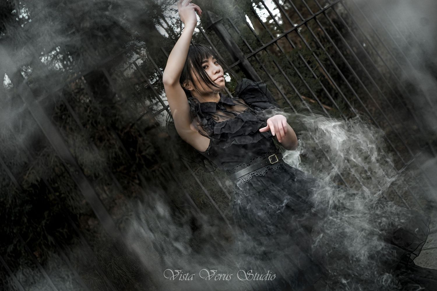 Artistic portrait with smoke effects and dramatic lighting against dark background.