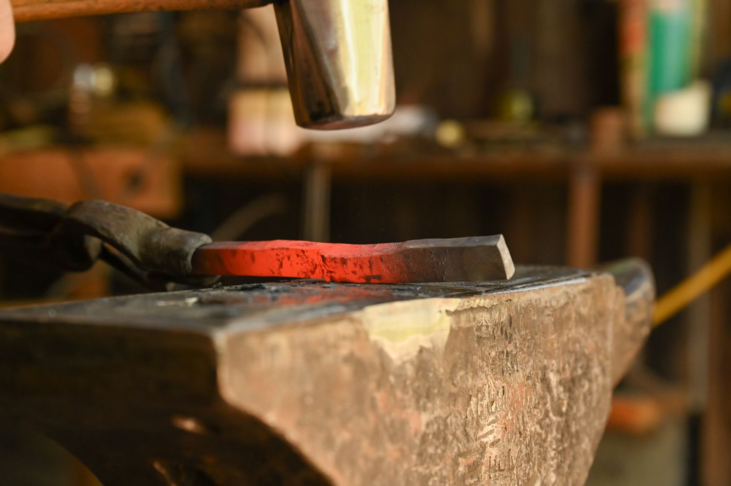 George B. Robb II uses a hammer to bang on a piece of metal