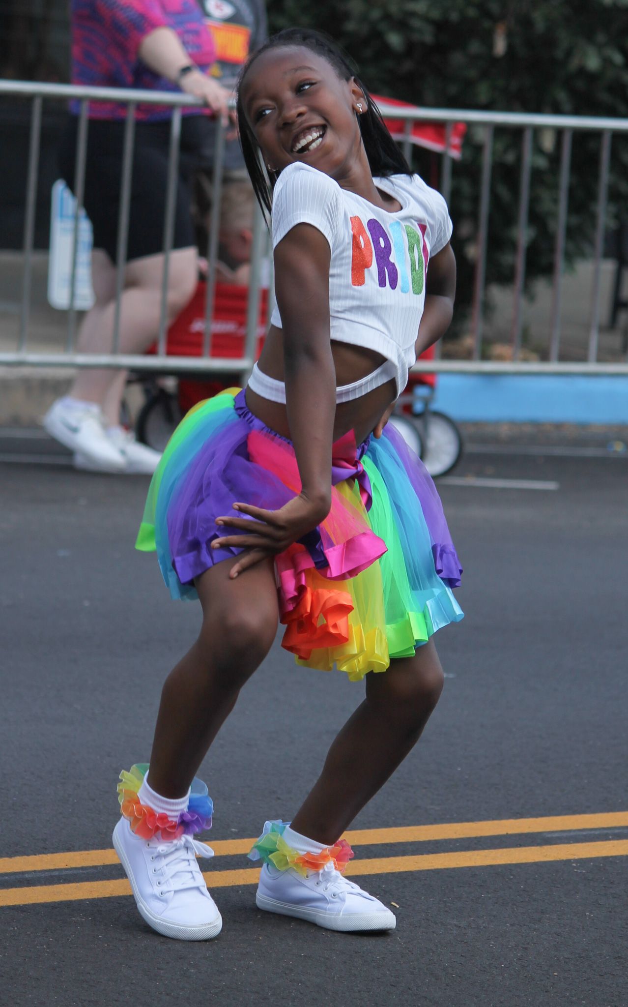 A young girl dances to the song “Run the World (Girls)” by Beyoncé during the Mid-Missouri Pride Fest parade