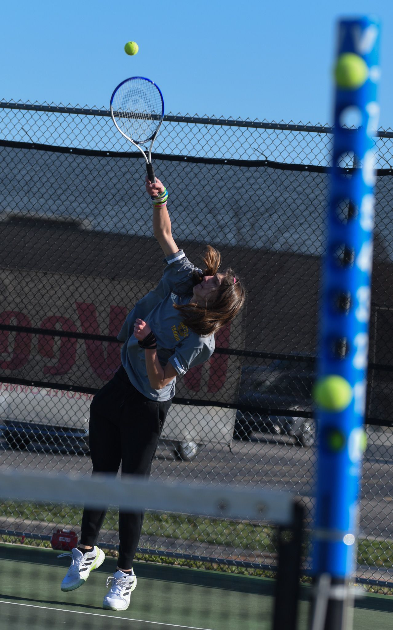 Battle junior Zachary Wood serves the ball in a match against Helias Catholic High School