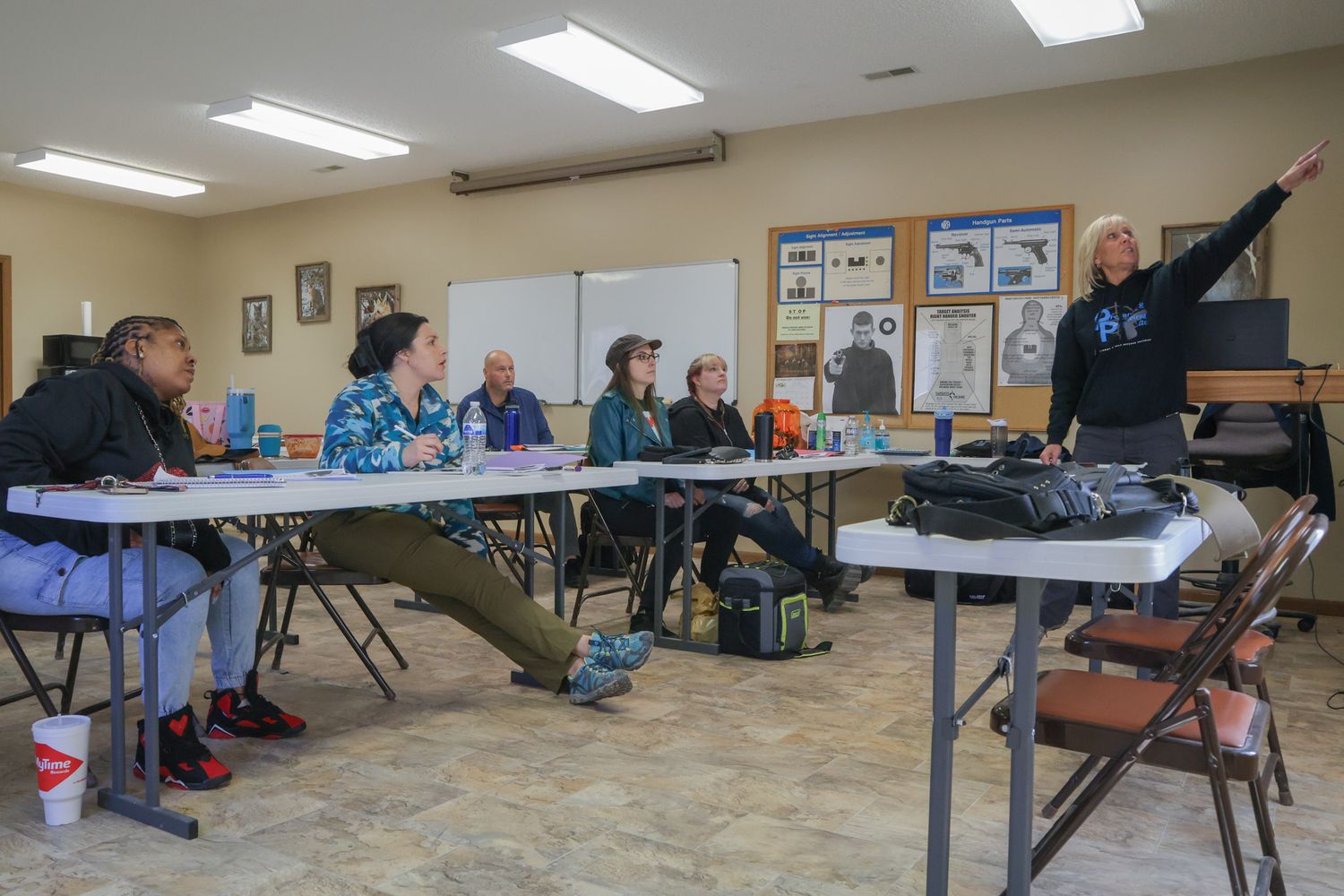 Amy Hess, right, talks to her concealed carry class about gun safety