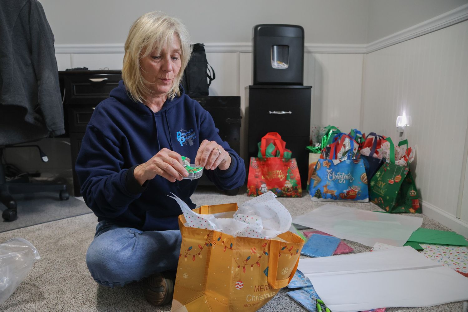 Amy Hess wraps presents for the members of her A Girl and A Gun club Christmas party