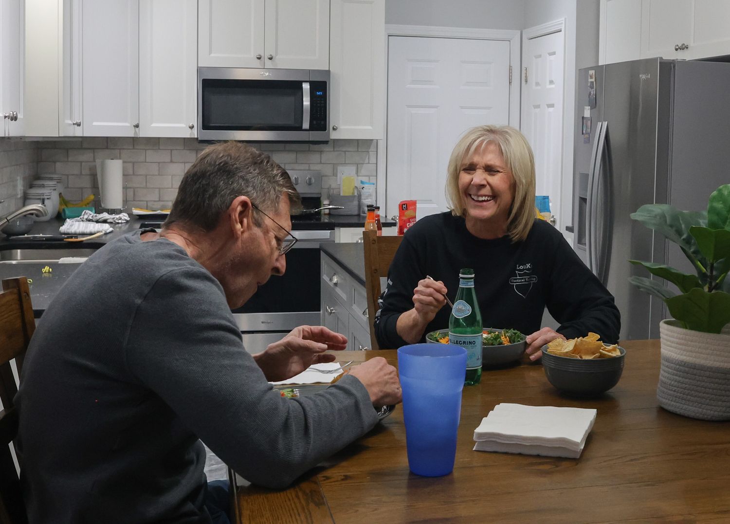 Amy Hess, right, eats dinner with her husband, Jerry Hess
