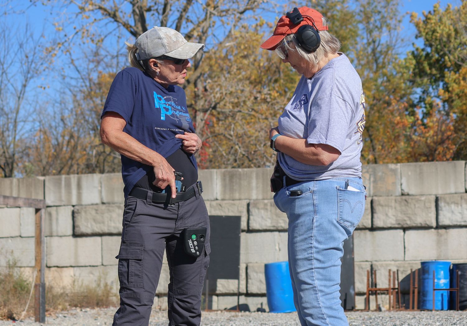 Amy Hess, left, shows her private session student C.E. how to properly draw her gun from its conceal sheath