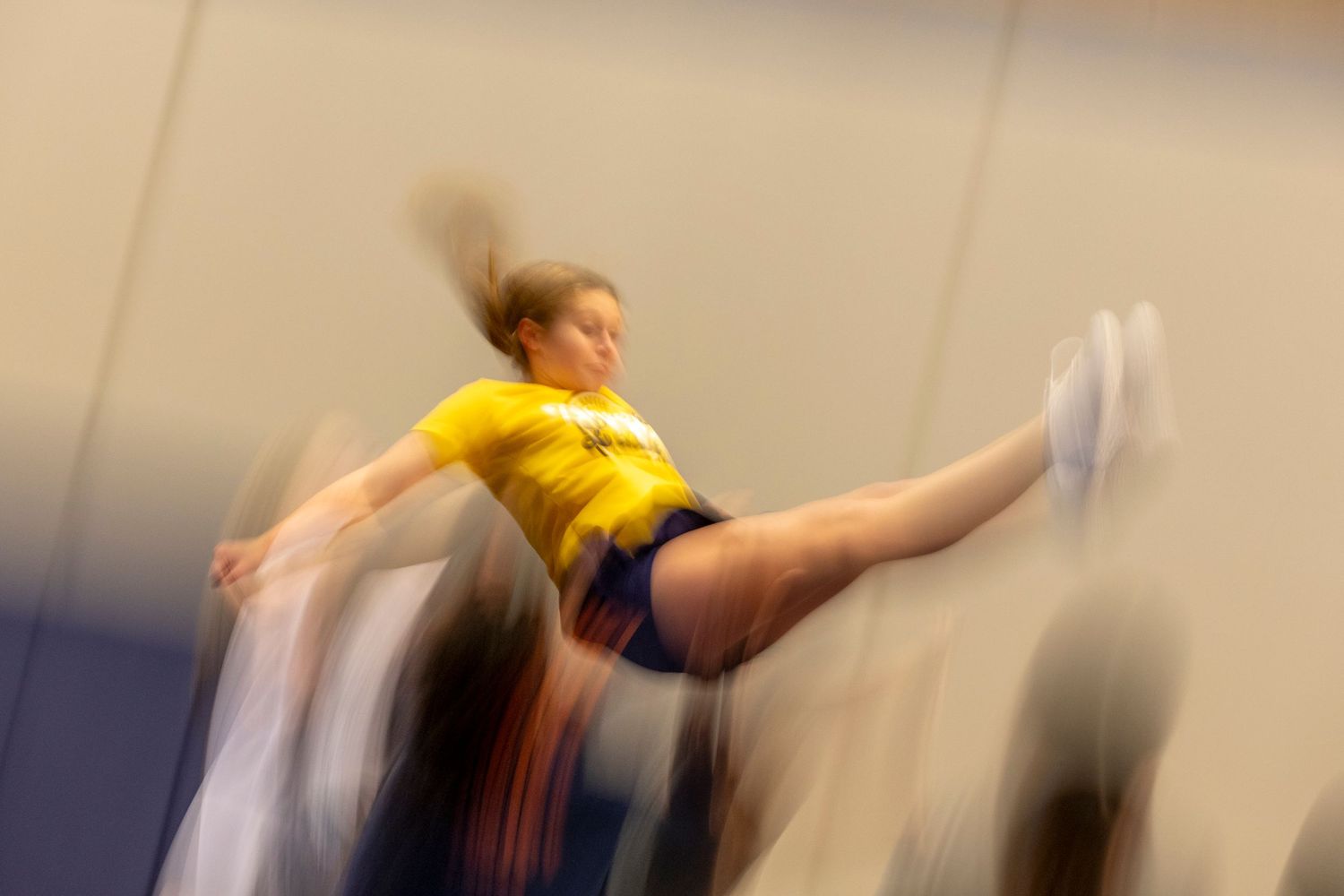 Addey Aldridge prepares to be caught by her teammates after performing a basket toss