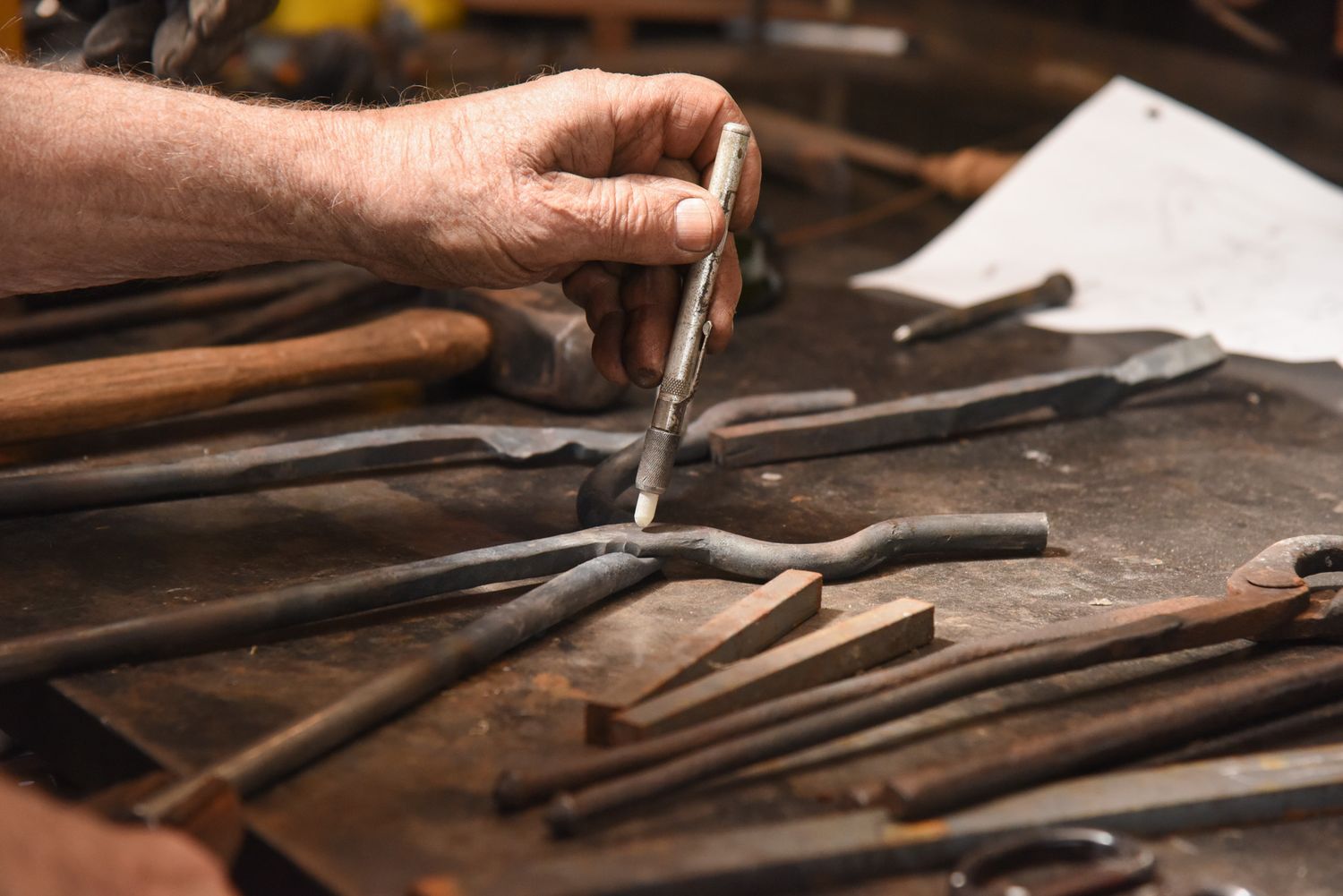 George B. Robb II makes a mark on a pair of tongs