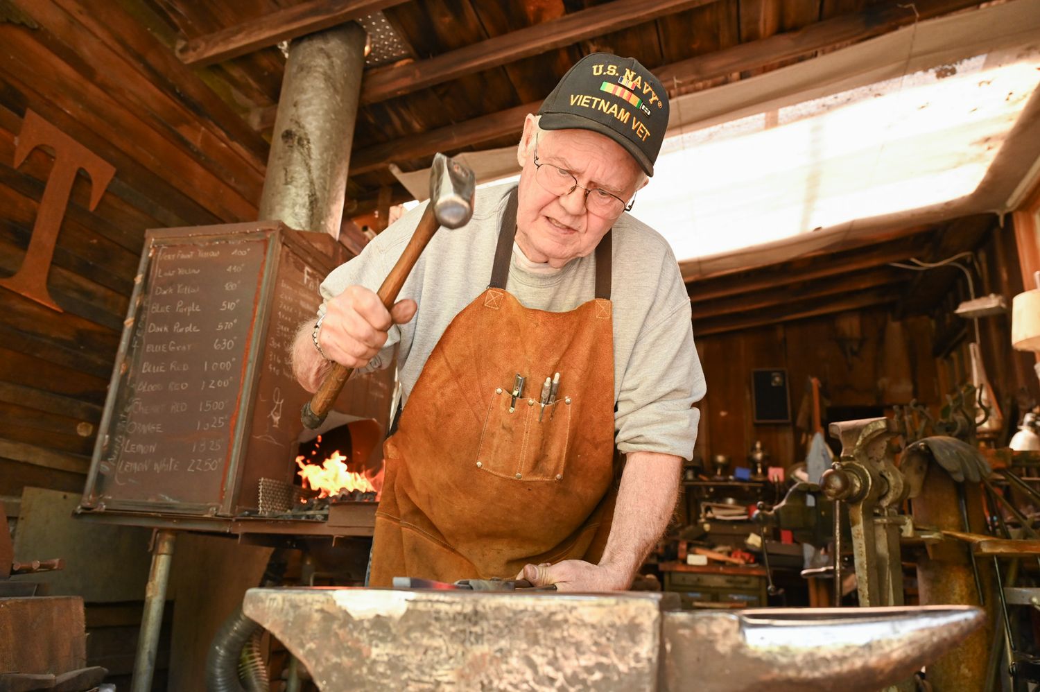 George B. Robb II rears back to hammer a piece of metal