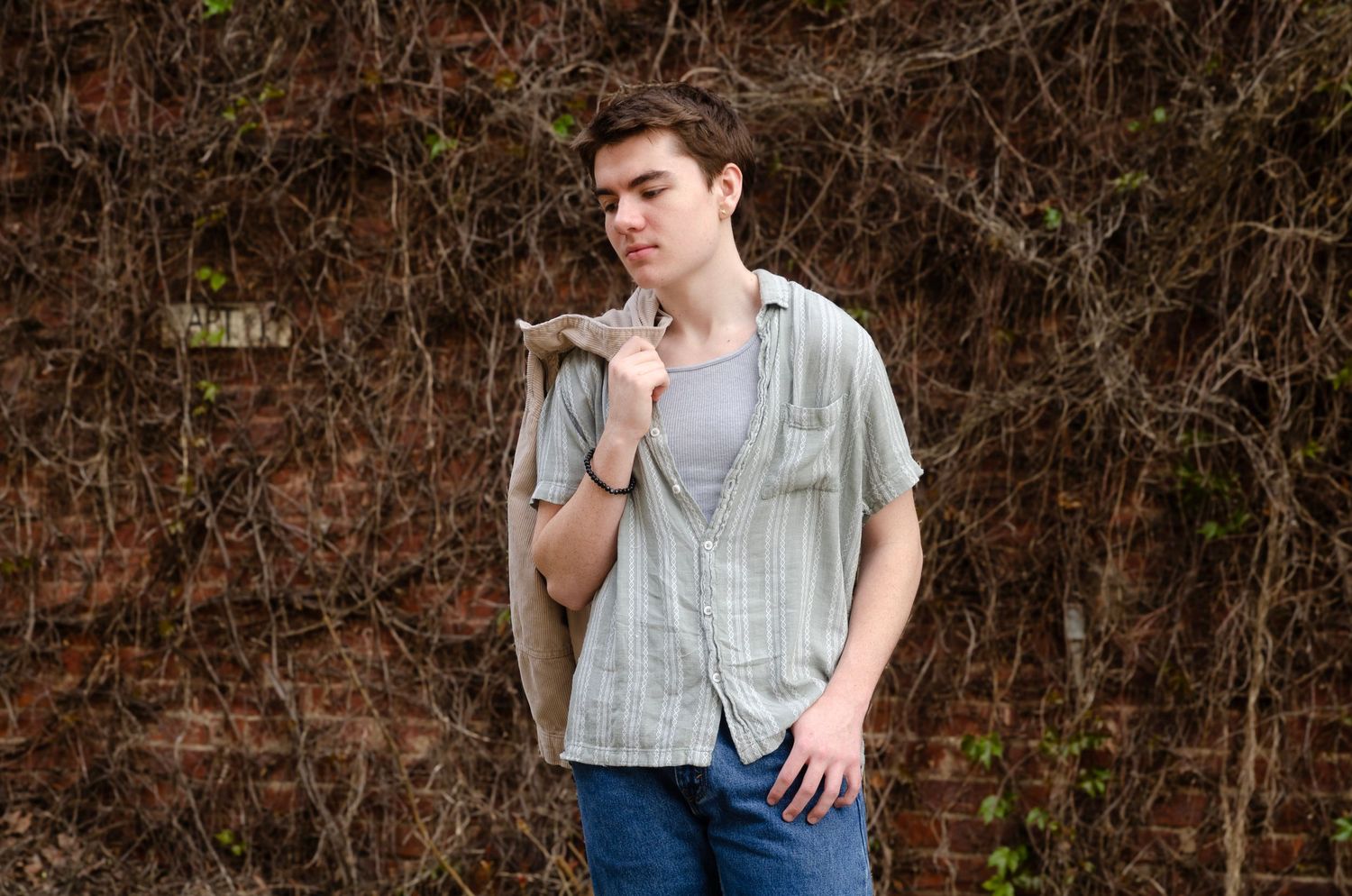 Casual outdoor portrait session in front of rustic brown foliage background. Senior photos by KM Conceptions Photography in Columbus, OH.