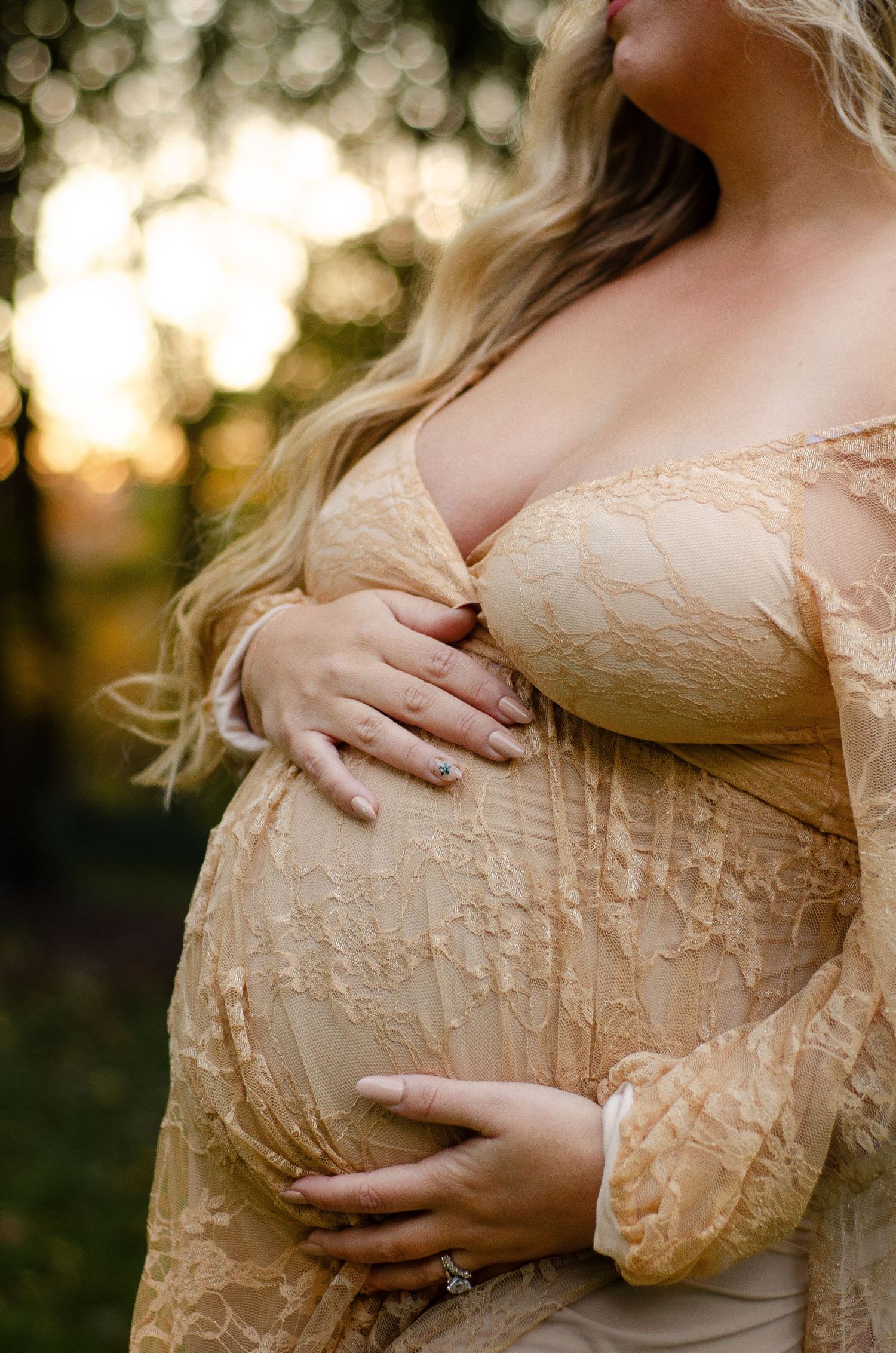 Close-up details of a peachy lace maternity gown in golden sunset light. Maternity photos by KM Conceptions Photography in Columbus, OH.