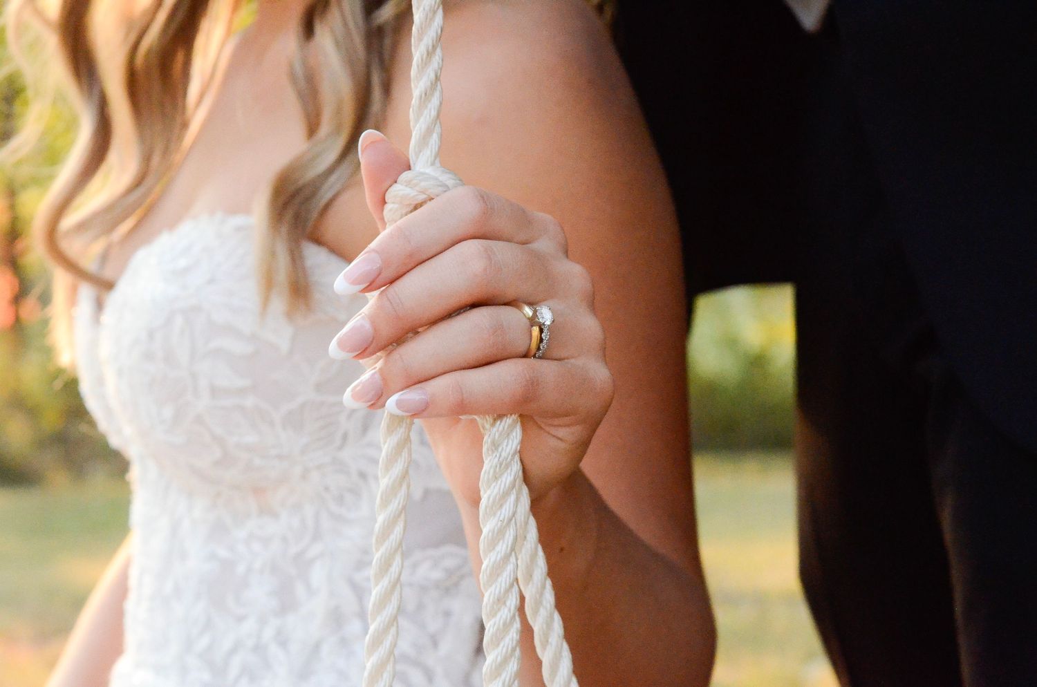Close-up of white lace wedding dress details. Wedding photos by KM Conceptions Photography in Columbus, OH.