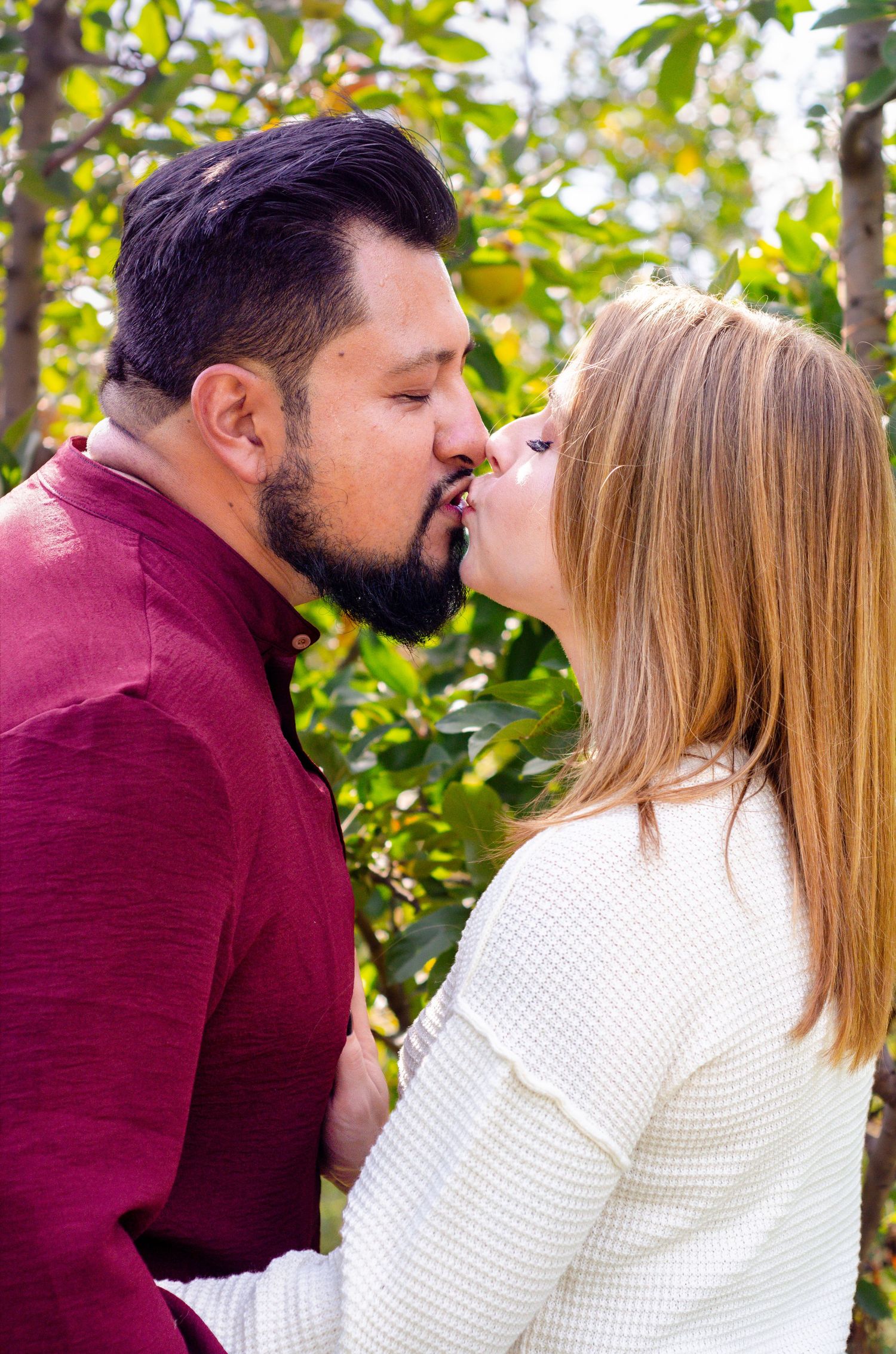 Romantic couple sharing tender moments in an outdoor setting with autumn foliage. Family photos by KM Conceptions Photography in Columbus