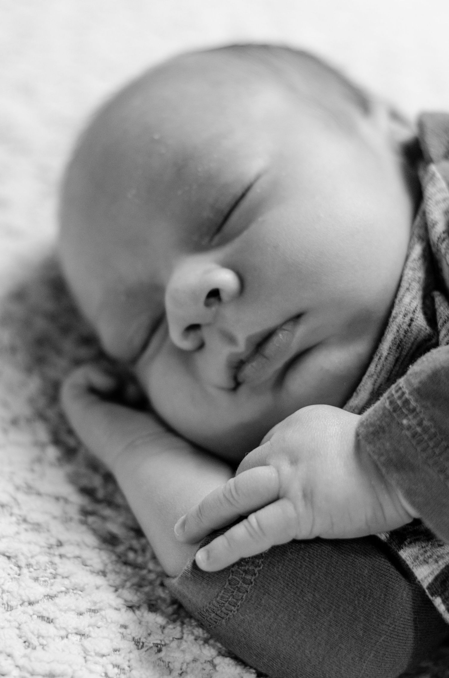 Peaceful sleeping baby in black and white with soft lighting. Newborn photography in Columbus, OH