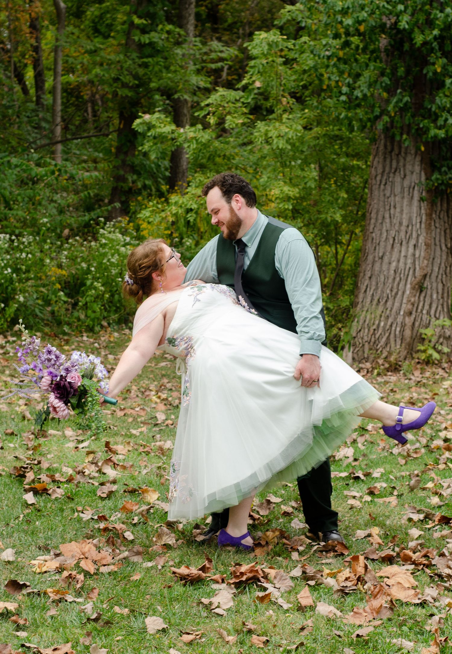 Playful dip pose on autumn leaves in a wooded setting. Photos taken by KM Conceptions Photography in Newark, OH.