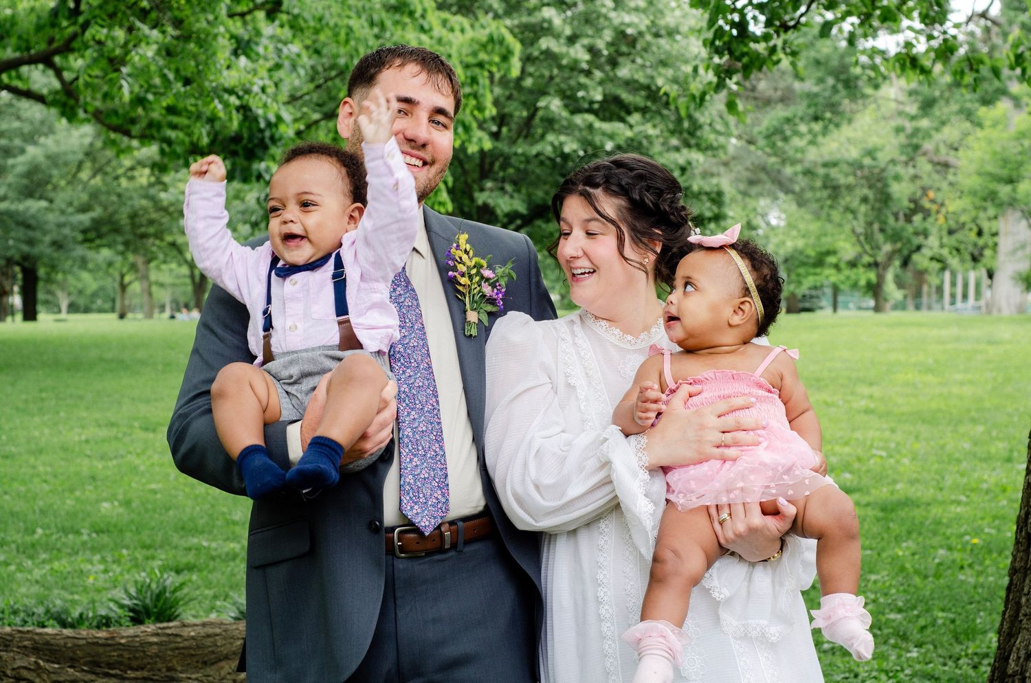 A joyful family portrait outdoors with small children and bride & groom. Wedding photos by KM Conceptions Photography in Columbus