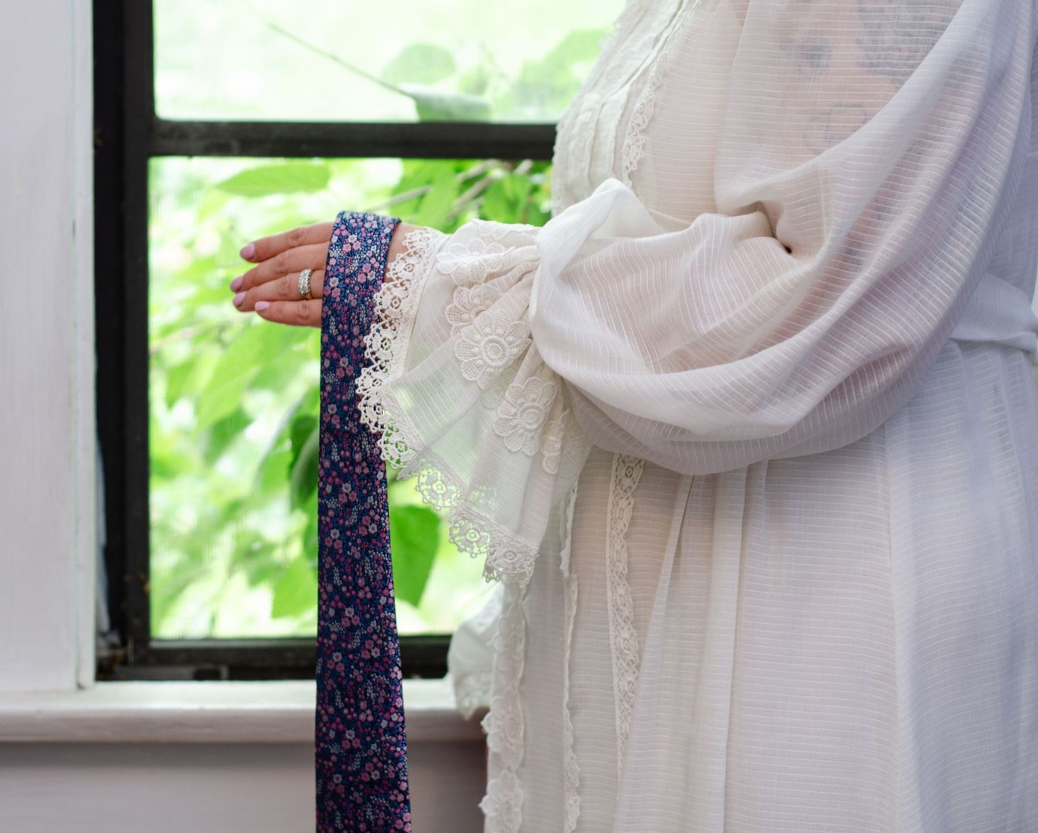 Close-up details of white wedding dress fabric and accessories. Wedding photos by KM Conceptions Photography in Columbus, OH.