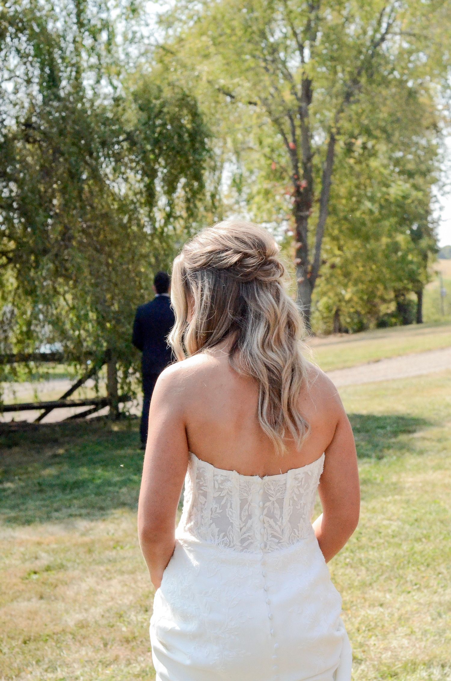 Back view of white lace wedding dress in outdoor garden setting. Wedding photos by KM Conceptions Photography in Columbus, OH.