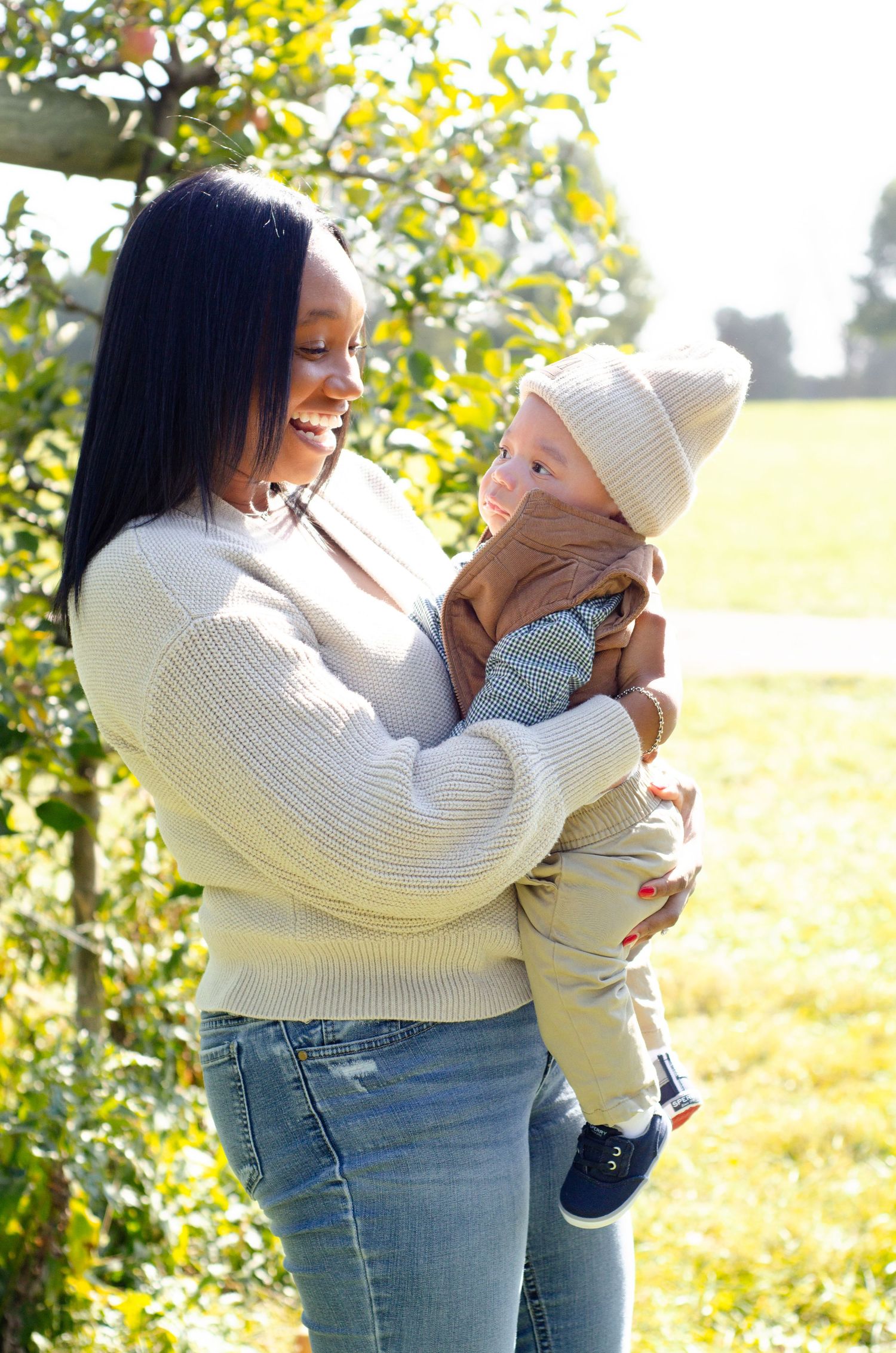 A sweet moment between parent and child in warm outdoor lighting. Family photos by KM Conceptions Photography in Columbus, OH.