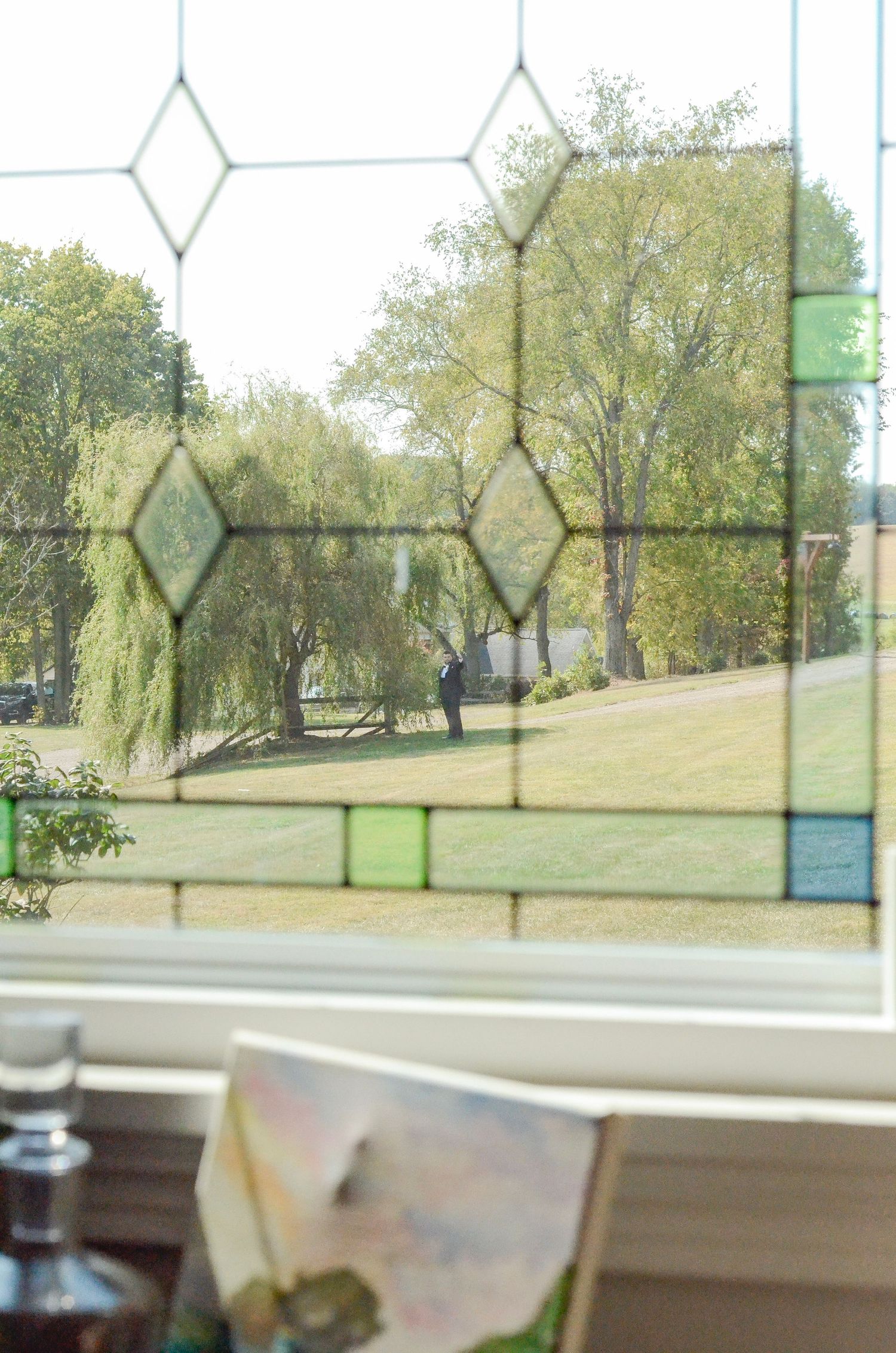 Decorative stained glass window pattern with geometric shapes and green accents. Wedding photos by KM Conceptions Photography in Danville