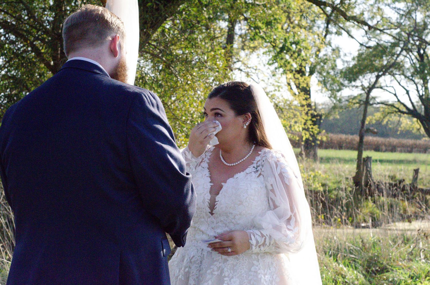 Newlyweds sharing a romantic moment outdoors in natural lighting. Wedding photos by KM Conceptions Photography in Columbus, OH.