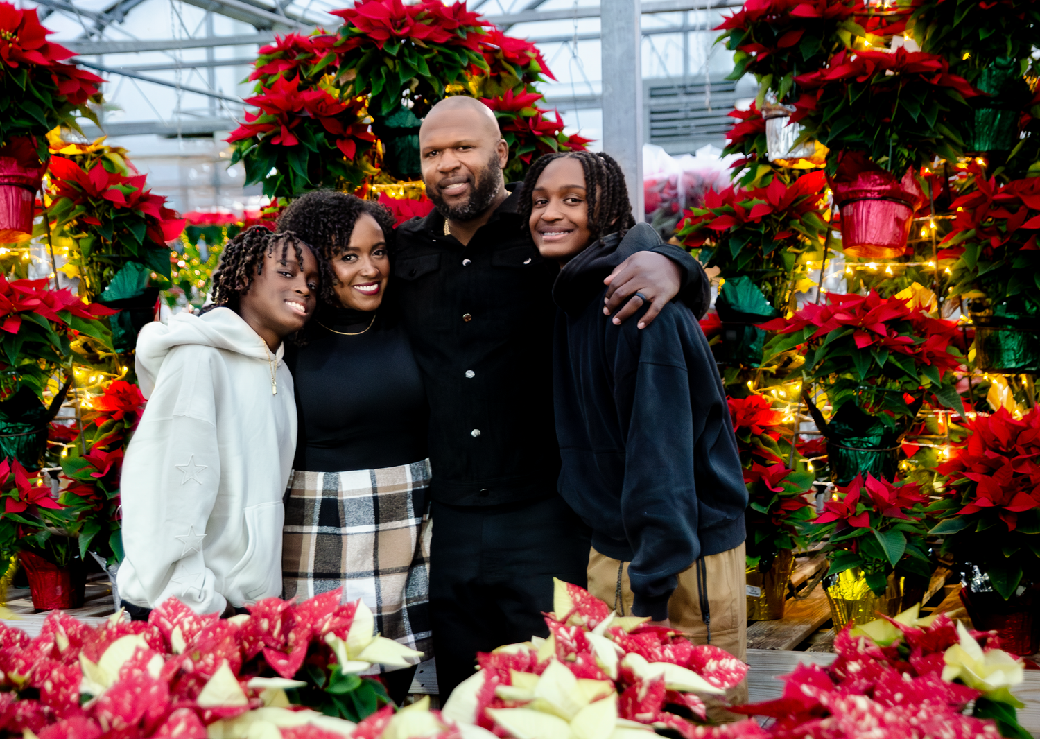 Holiday greenhouse scene with abundant red poinsettias and festive decorations. Photos by KM Conceptions Photography.