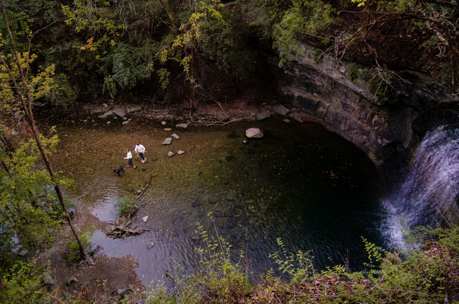Natural waterfall cascading over rocky cliffs in a wooded setting. Family photos by KM Conceptions Photography in Columbus, OH.