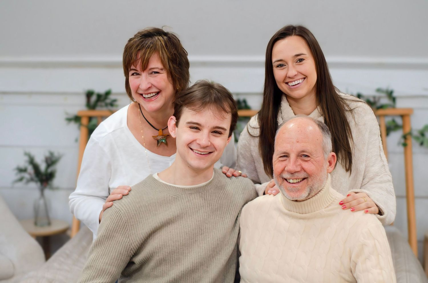 Group shares warm moments together in casual indoor setting.