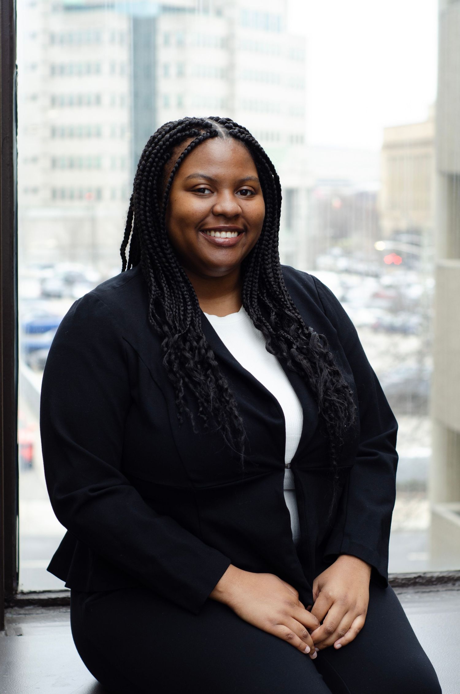 Professional portrait session in an office building with city views.