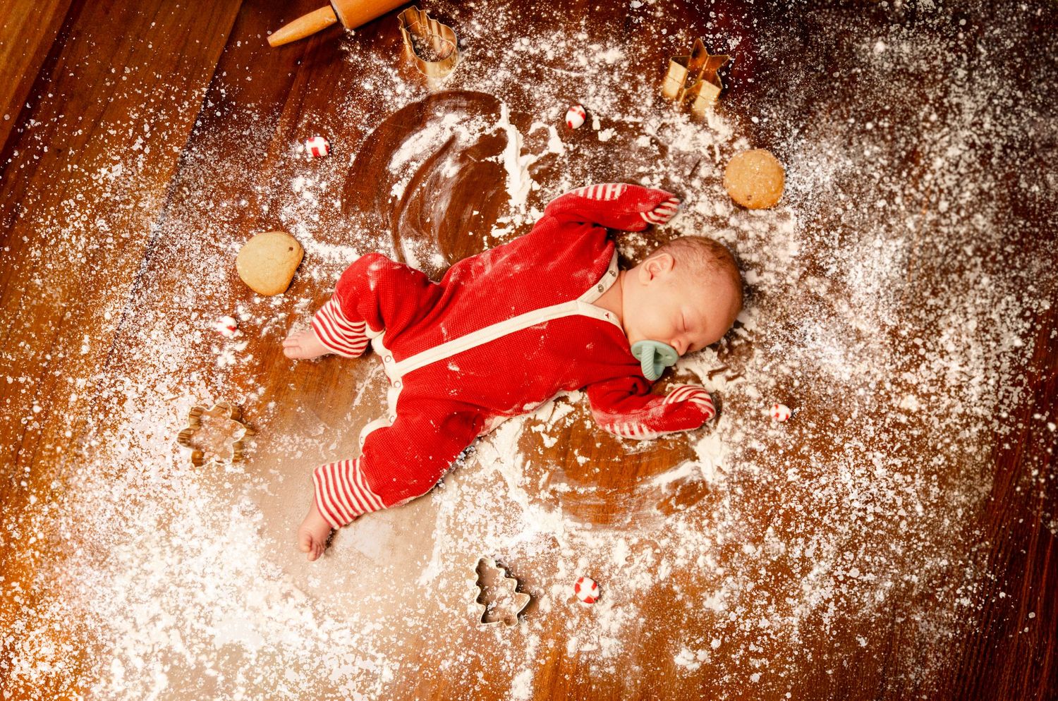 Baby surrounded by scattered flour and cookie crumbs. Newborn photography in Columbus, OH
