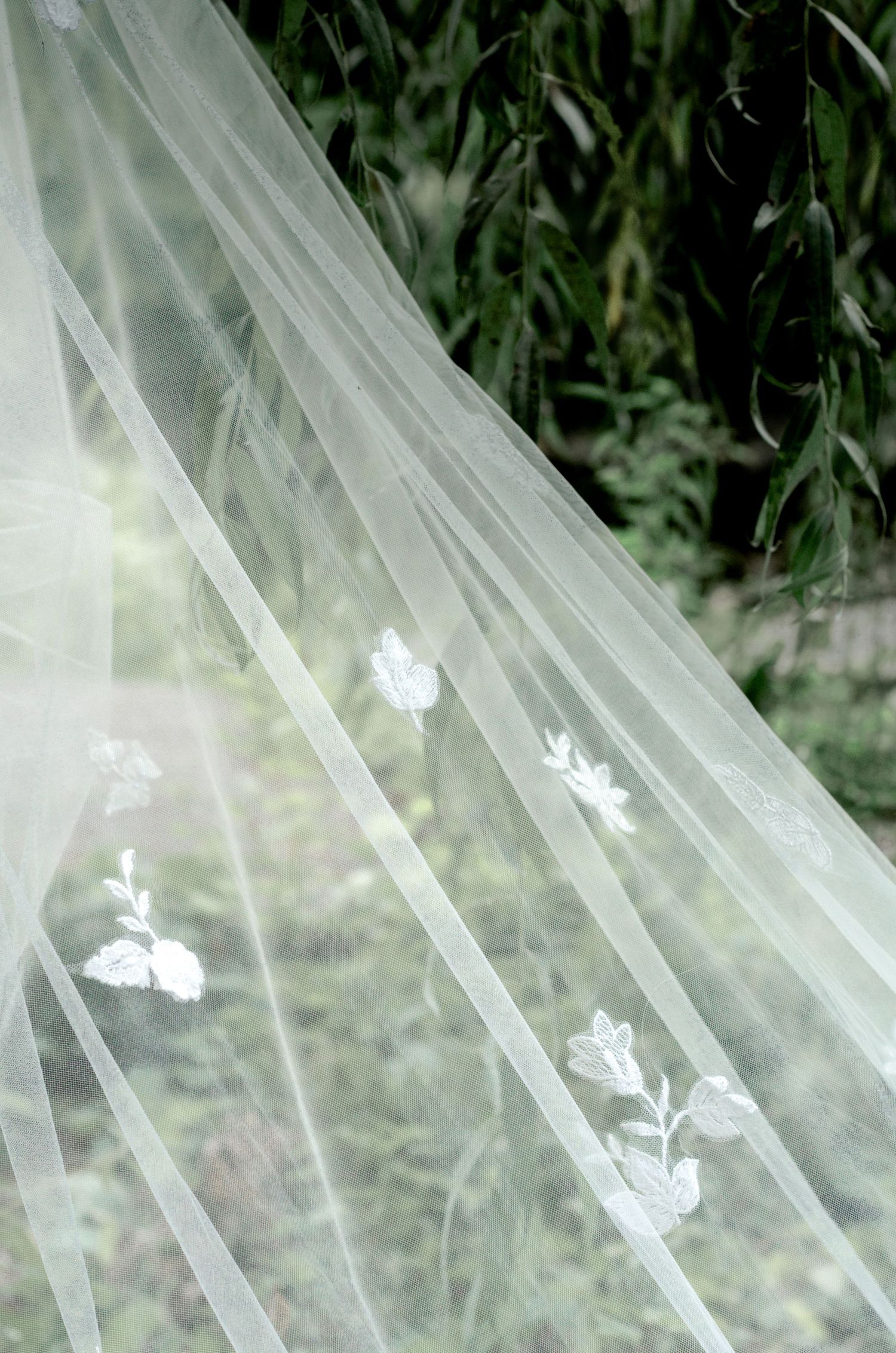 Delicate white sheer wedding veil against natural backdrop. Wedding photos by KM Conceptions Photography in Columbus, OH.