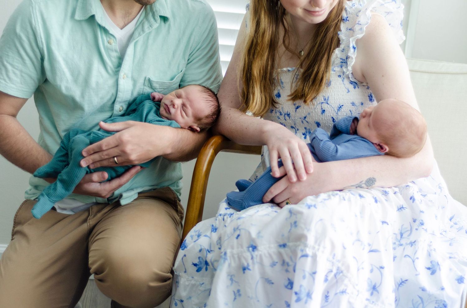 Indoor family photoshoot with soft lighting and neutral tones featuring a newborn. Newborn photos by KM Conceptions Photography in Columbus