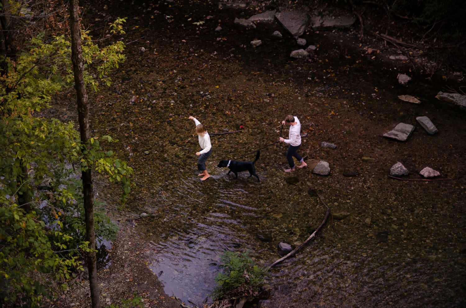 Aerial view of a waterfall in Columbus, OH with scattered rocks and autumn trees. Photos by KM Conceptions Photography.