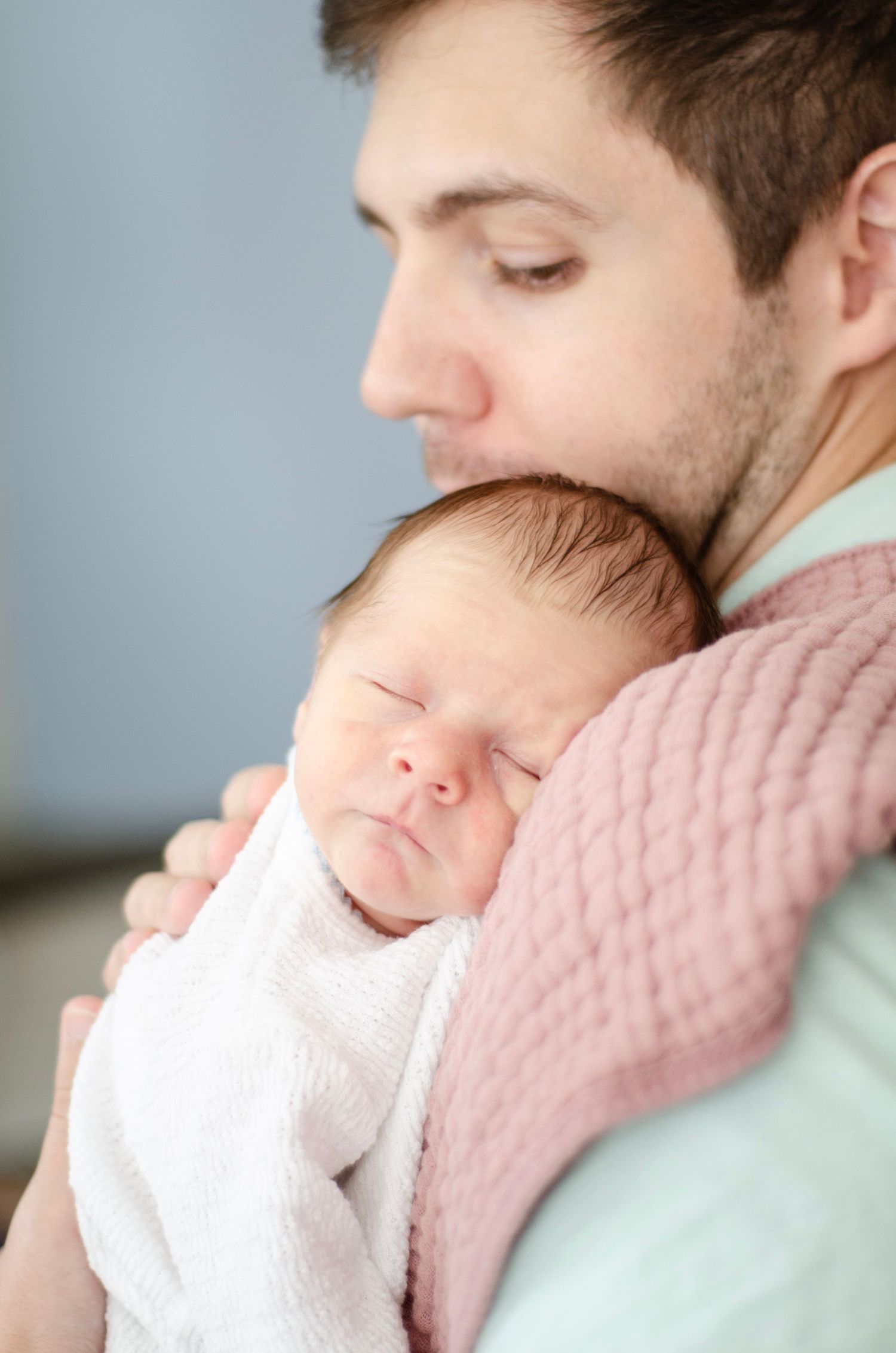 Tender newborn photography sequence showing gentle cuddles. Newborn photos by KM Conceptions Photography in Columbus, OH.