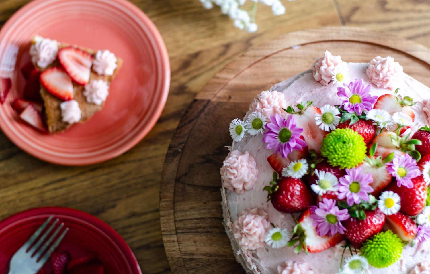 Pink plates with floral decorations and desserts on rustic wooden table. Wedding photos by KM Conceptions Photography in Columbus, OH.