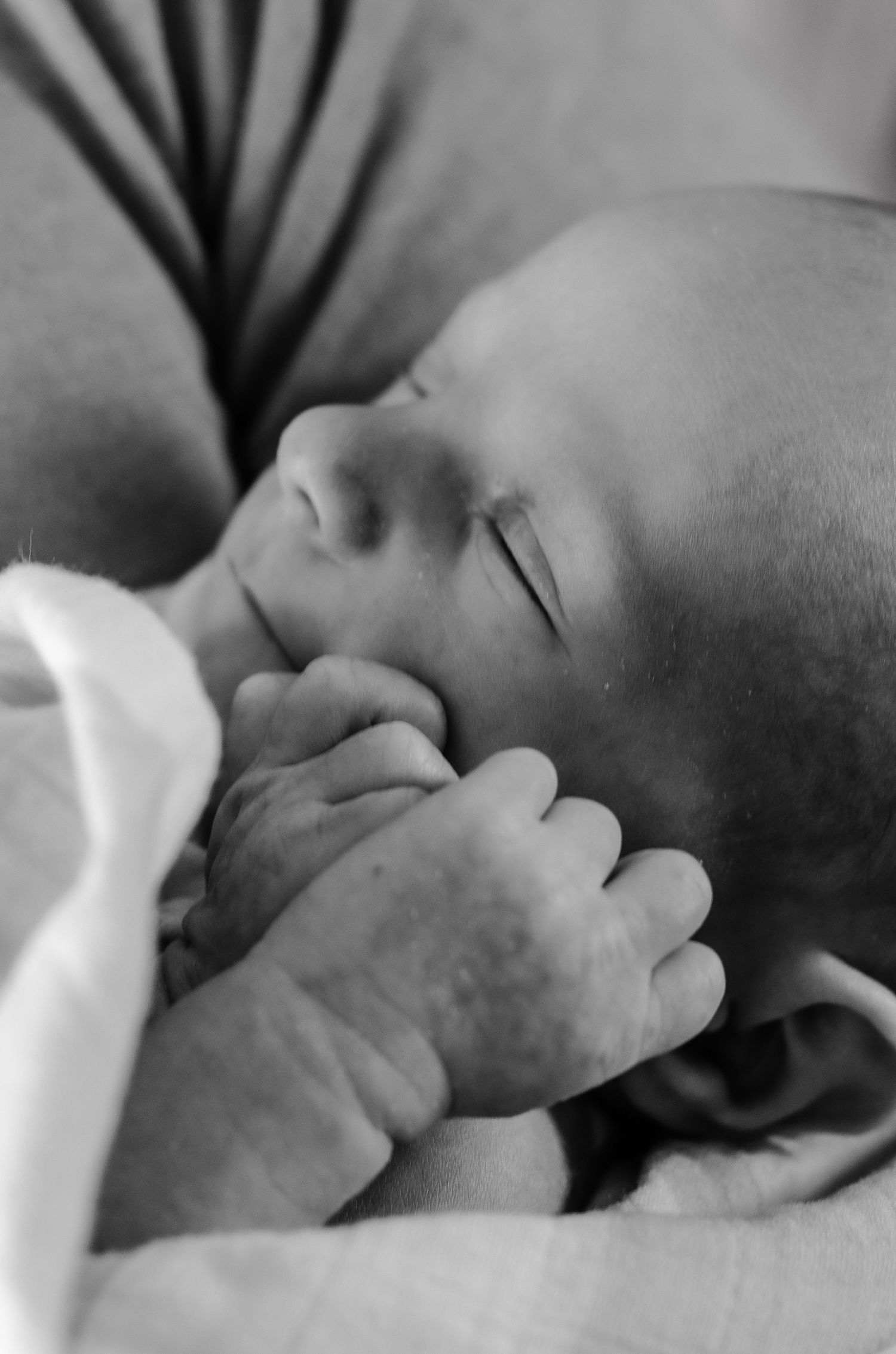 Black and white close-up image showing gentle touch and connection. Newborn photos by KM Conceptions Photography in Columbus