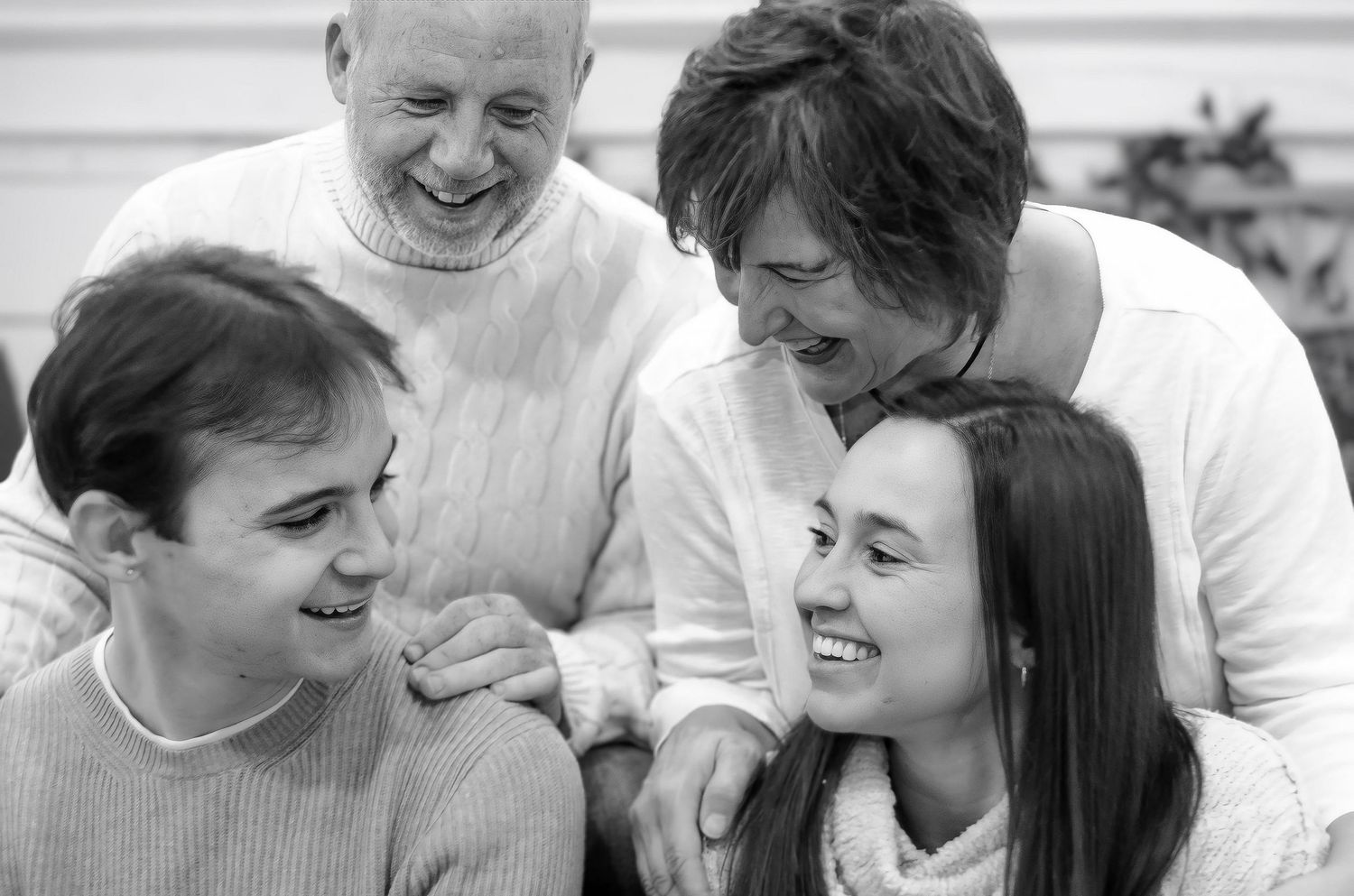 Black and white candid shots showing joyful interactions between group members.