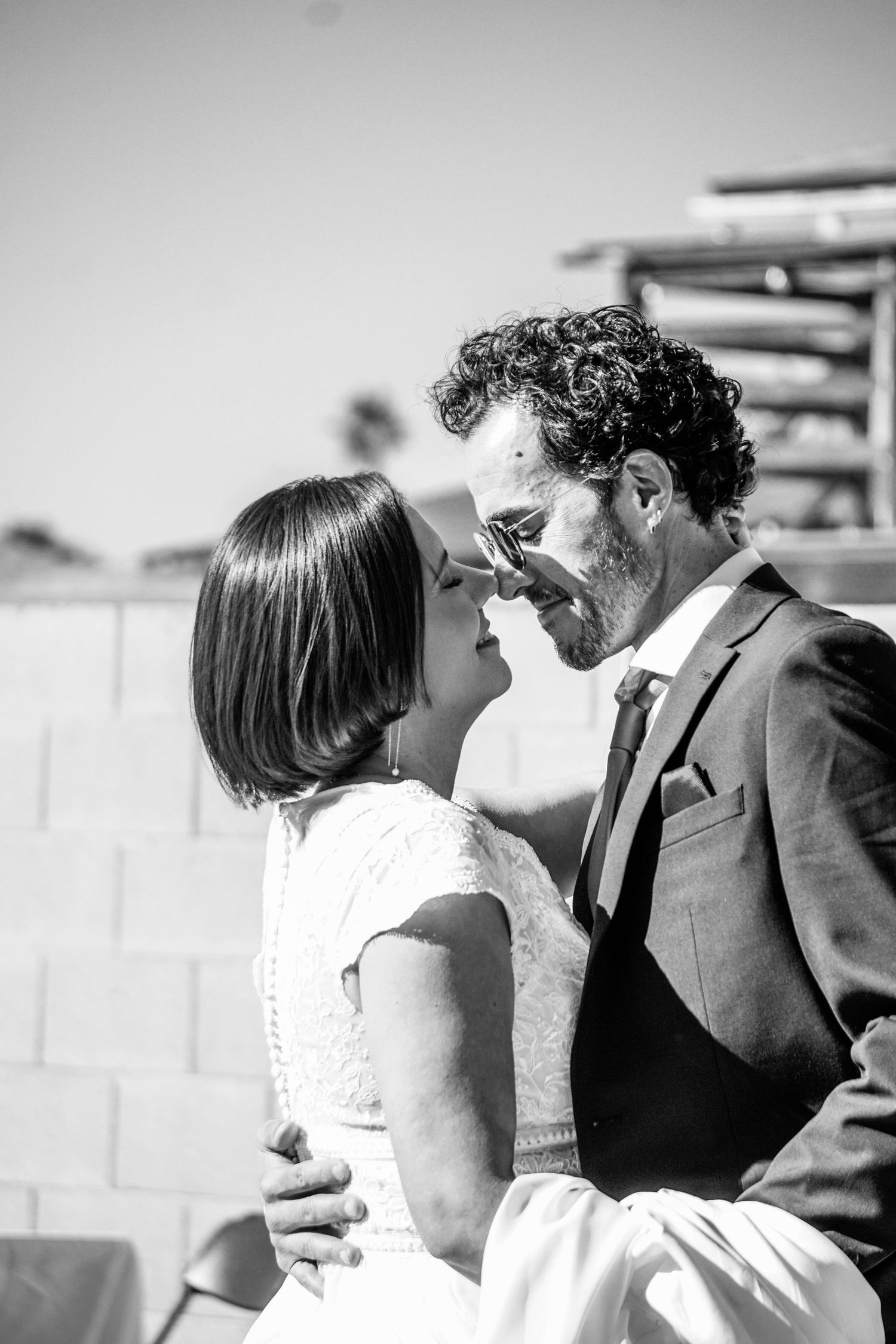 Black and white wedding photo sequence showing romantic moments between newlyweds.
