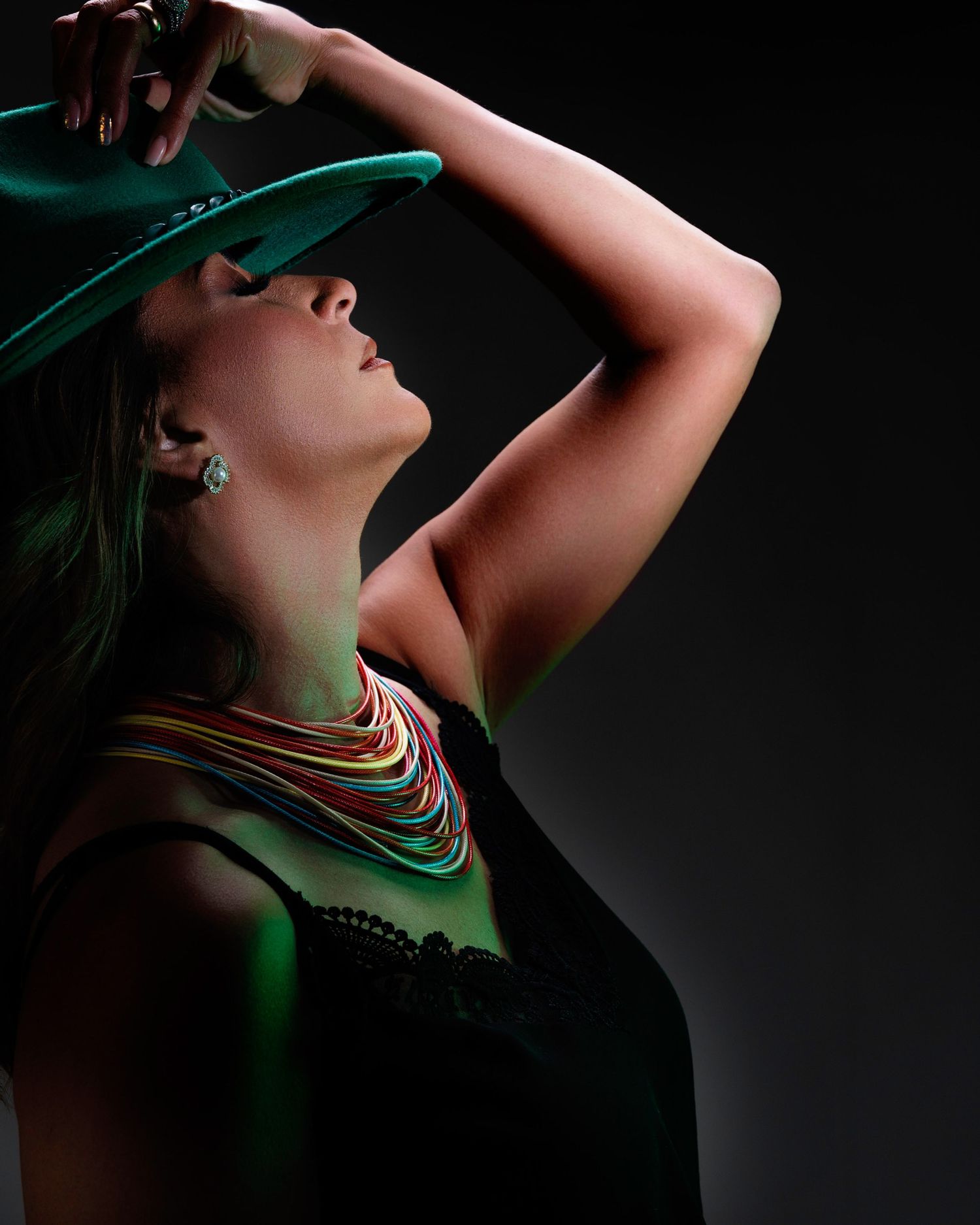 Experience the power of bold gel lighting in portrait photography. Book your professional studio session in Houston today