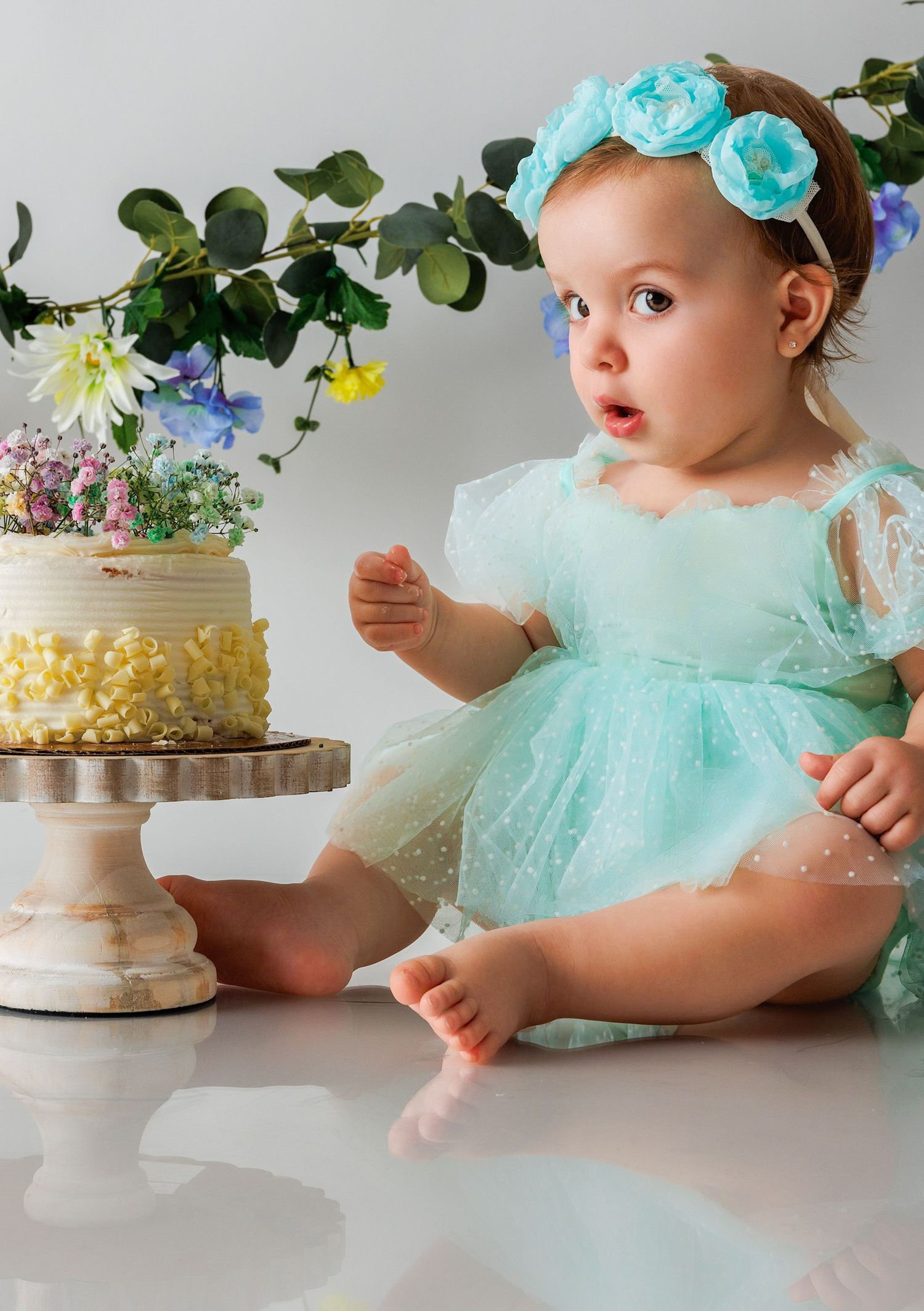 Beautiful cake smash session capturing a baby’s first birthday. Soft pastel colors and elegant photography in Houston, Texas.