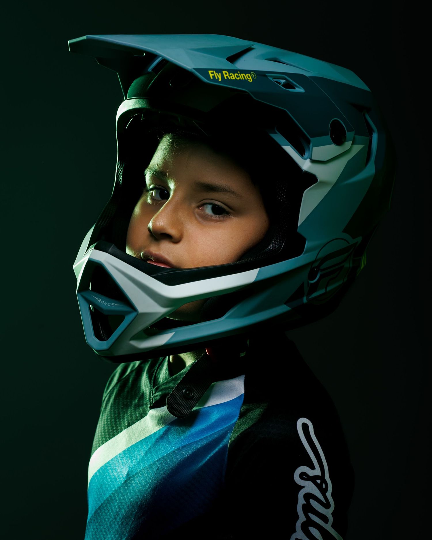 Dynamic portrait of a young BMX rider in a bold studio setting. Perfect for sports branding, racing enthusiasts, and action photography