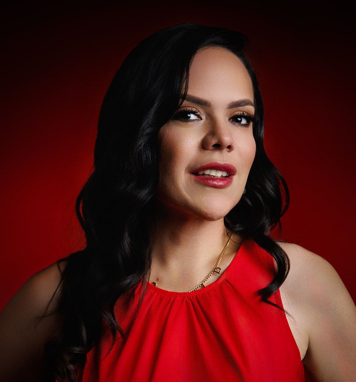 Luxury branding portrait of a confident woman in red, shot with dramatic lighting. High-end business photography in Houston, Texas.