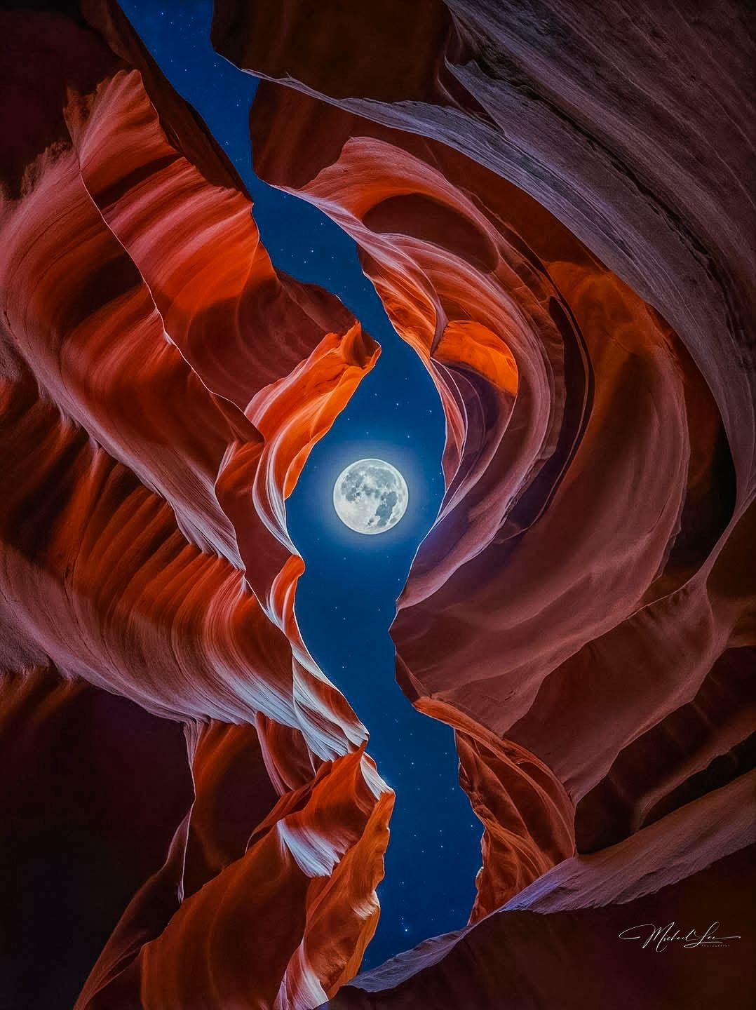 Full moon visible through a narrow slot canyon opening with red sandstone walls creating dramatic framing.