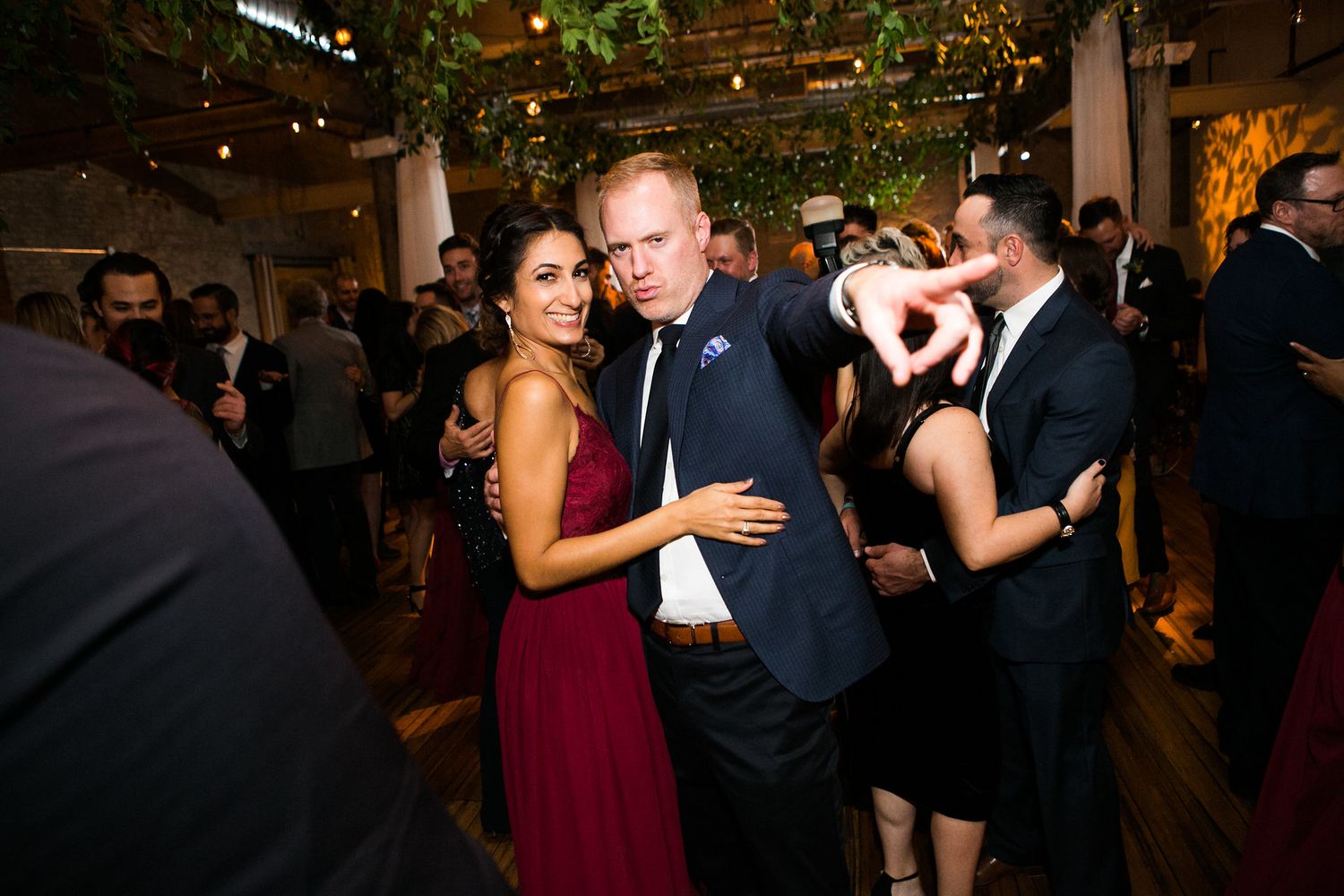 Couple dancing closely together at elegant wedding reception.