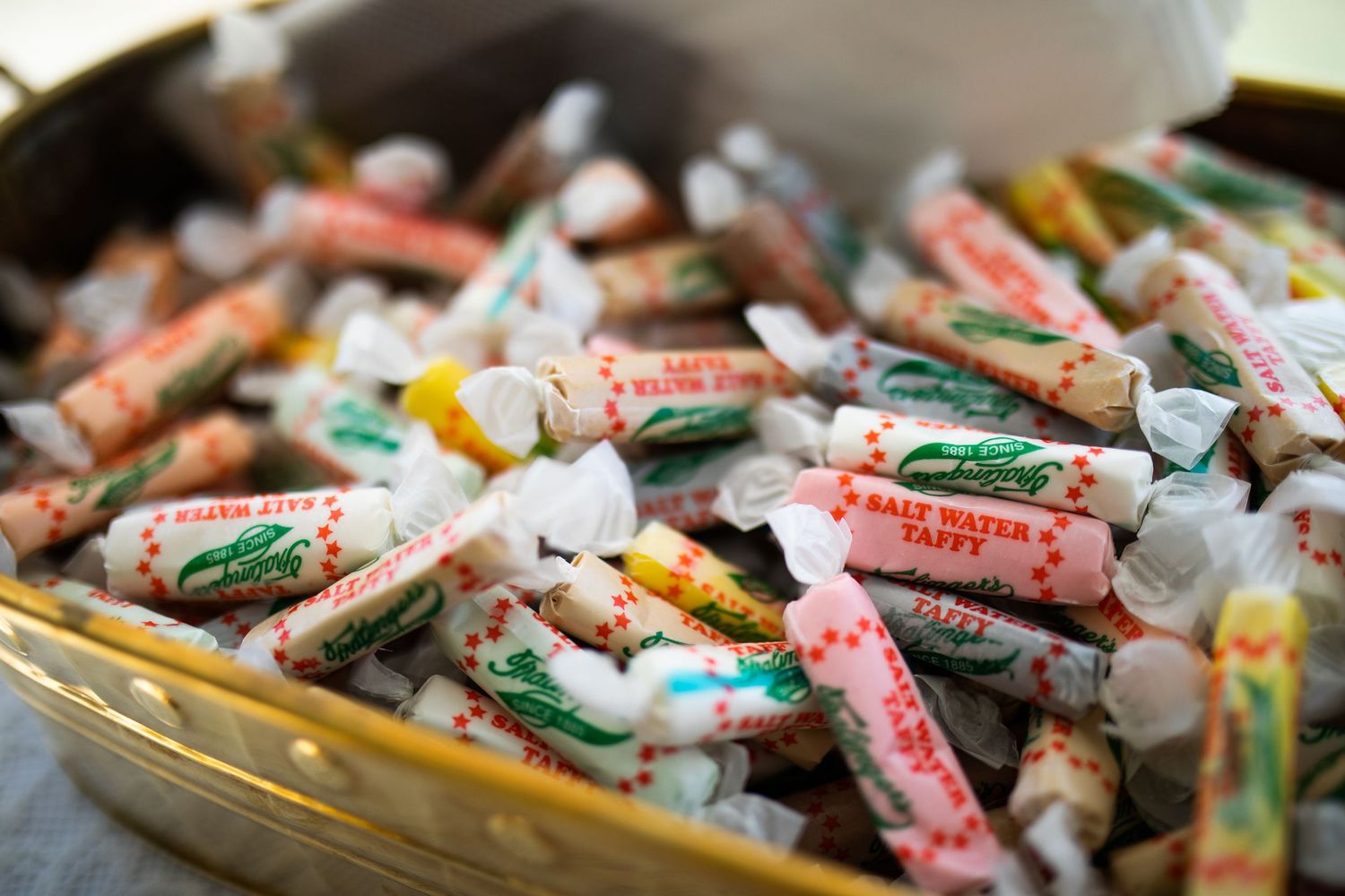 Colorful assortment of Salt Water Taffy candies in a gold dish at wedding.