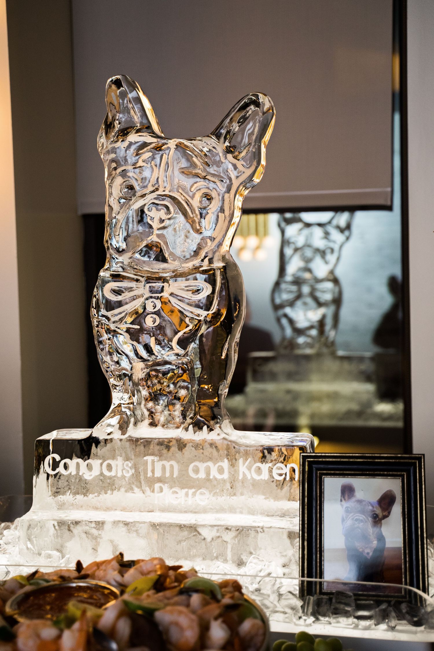 Custom French Bulldog ice sculpture congratulating Tim and Karen at an elegant wedding reception.