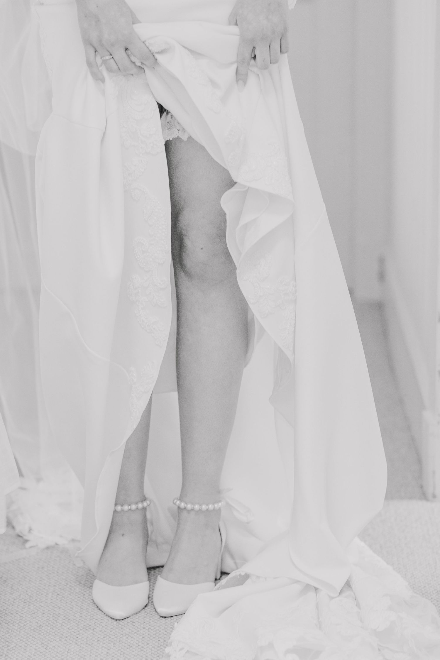 girl in wedding dress, legs close up with garter showing