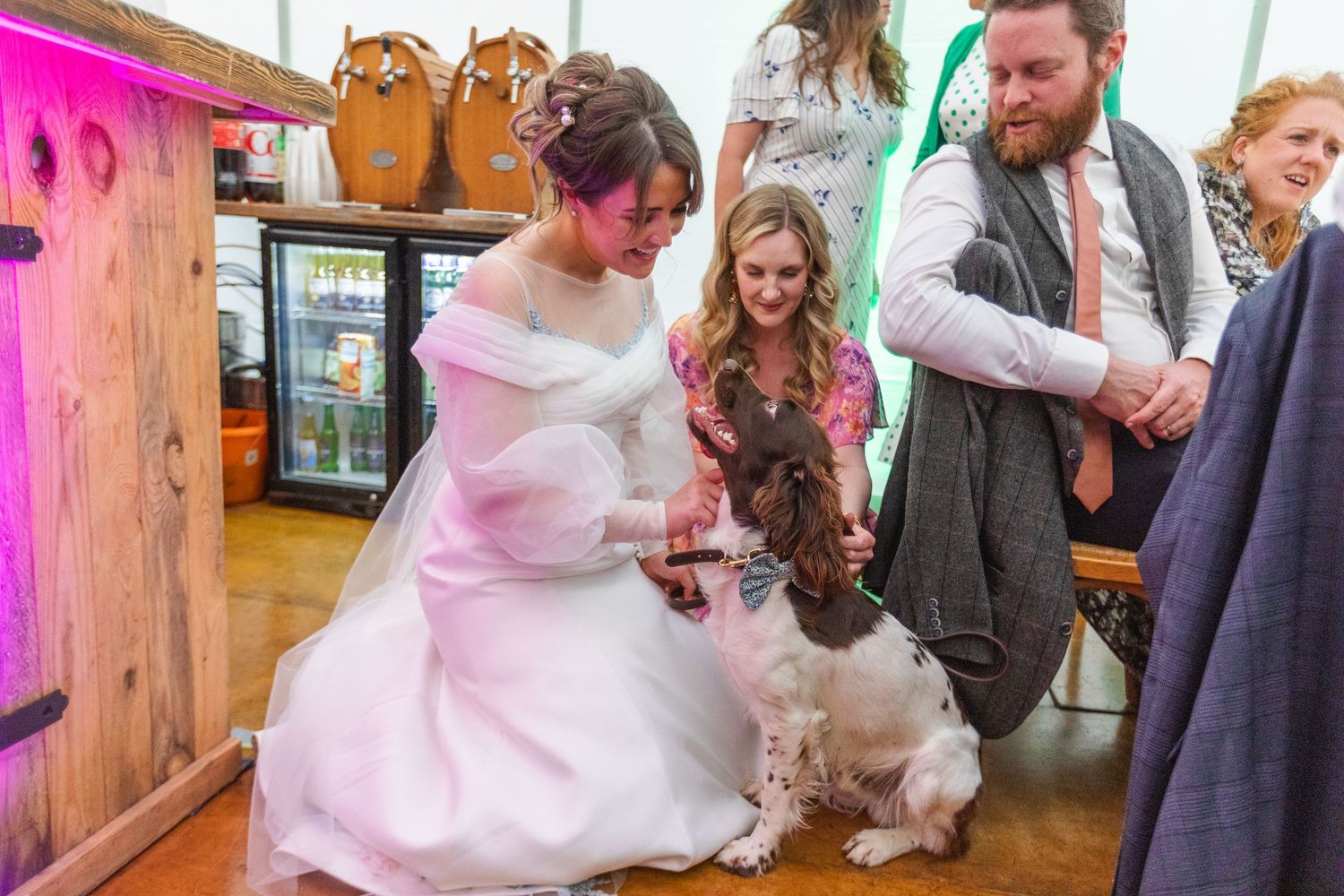 Bride on the floor having a relaxed and candid moment with her dog