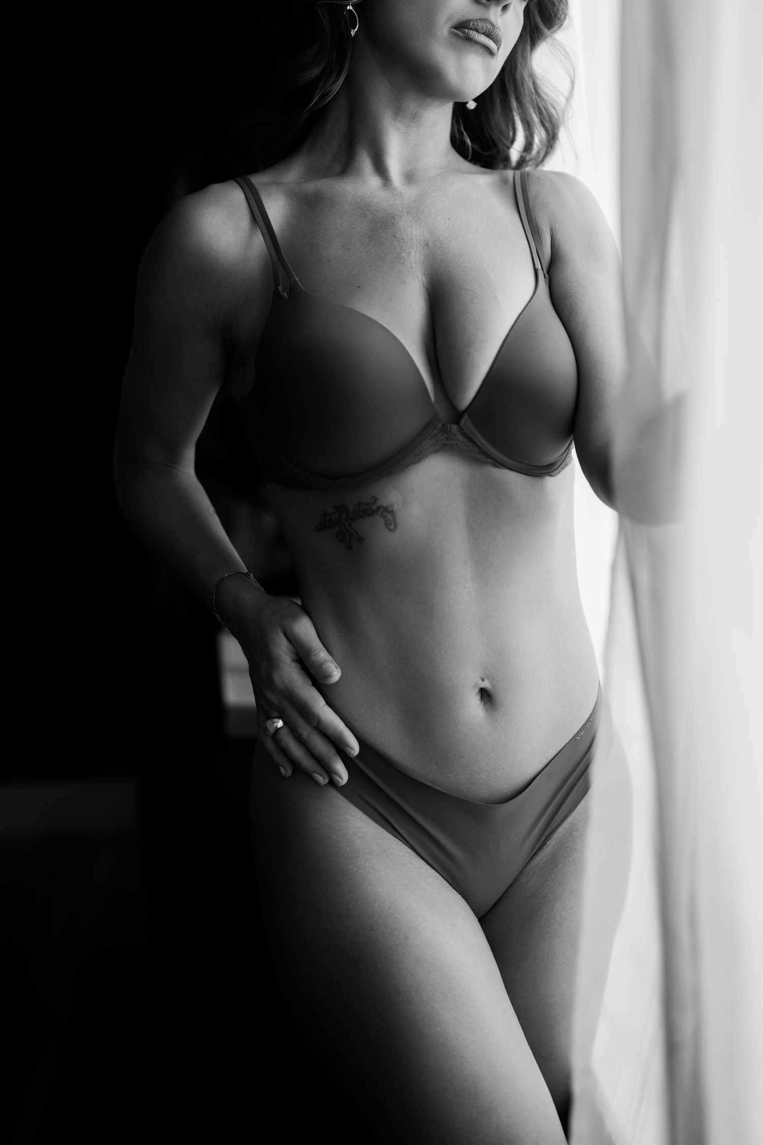 black and white boudoir portrait, featuring elegant lingerie and artistic body silhouette by Orlando boudoir photographer shoots with Kay