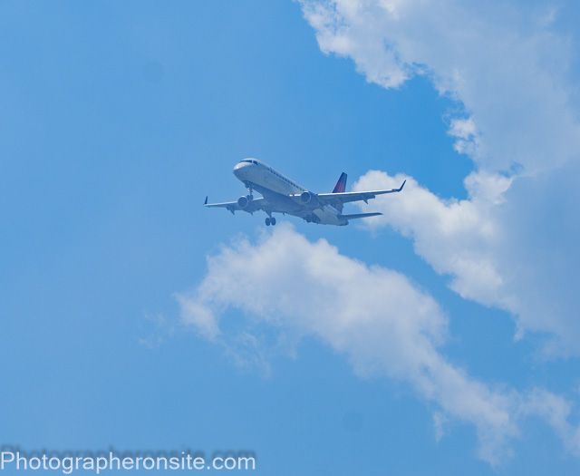 nice aviation image with an airplane framed by clouds.